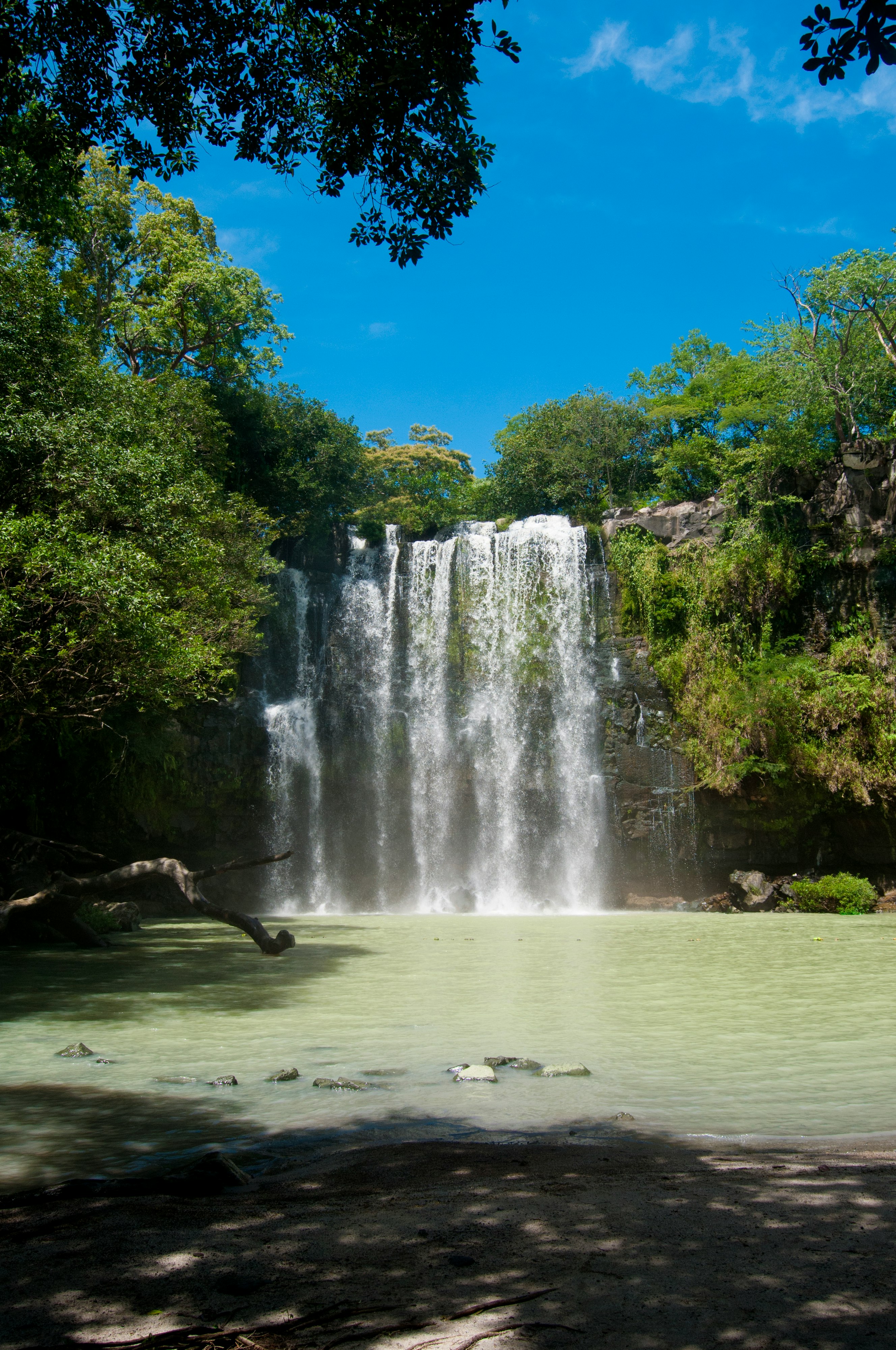 water falls on green grass field during daytime